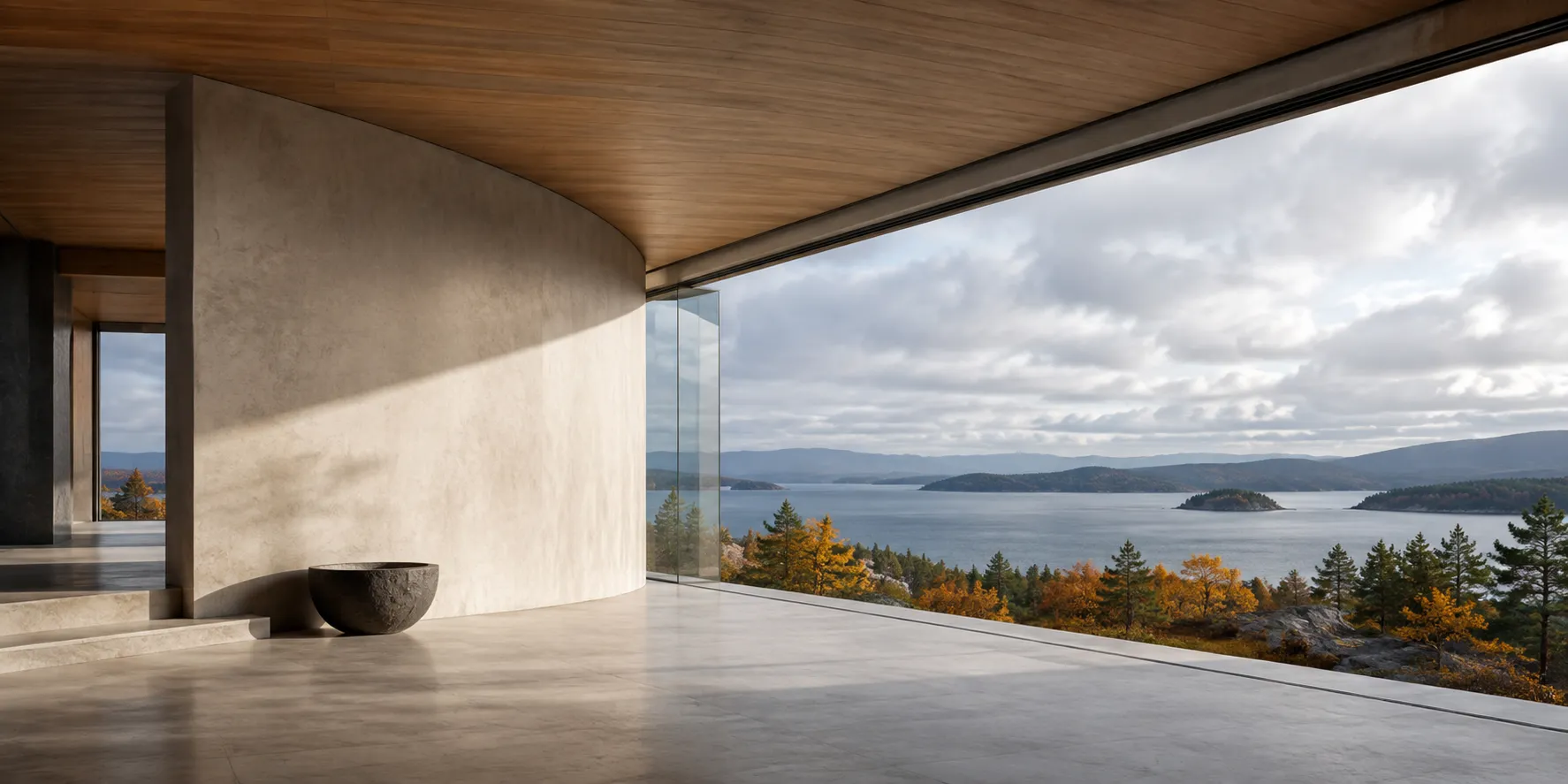 Curved architectural space opening onto a lake and autumn landscape